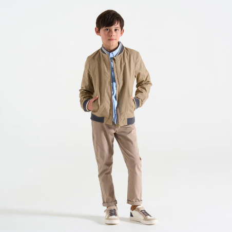 Boy's beige fabric baseball jacket.